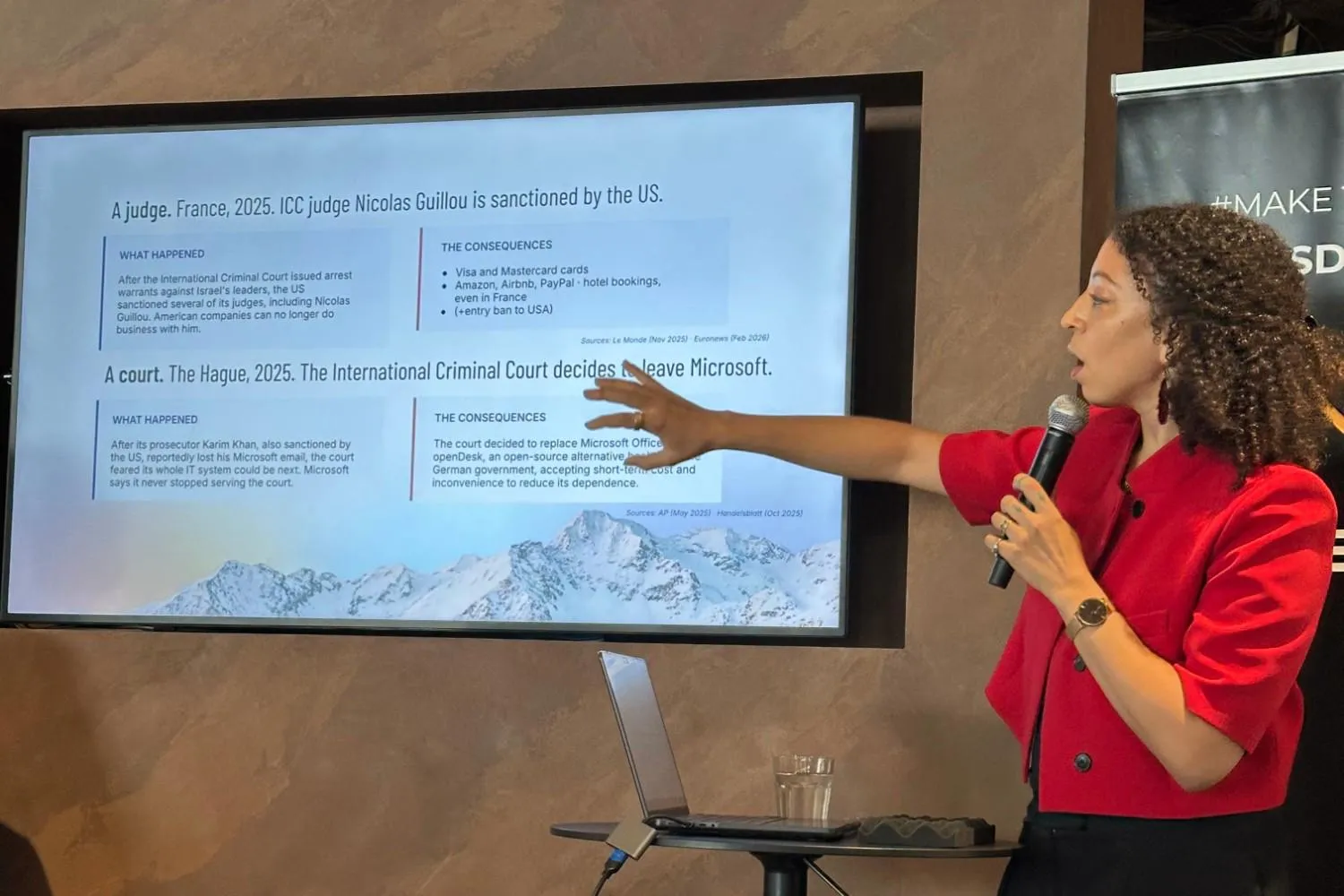 Alice Ballé presenting a slide about ICC judge Nicolas Guillou being sanctioned by the US, and the International Criminal Court deciding to leave Microsoft